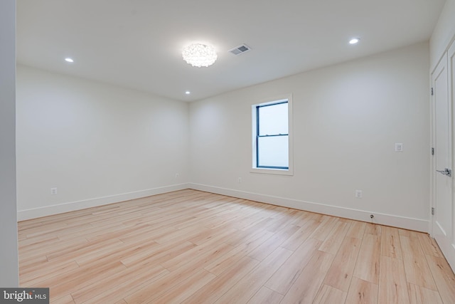 spare room with light hardwood / wood-style flooring