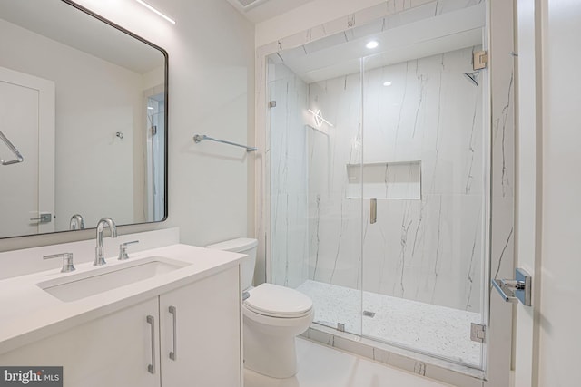 bathroom with vanity, toilet, and an enclosed shower