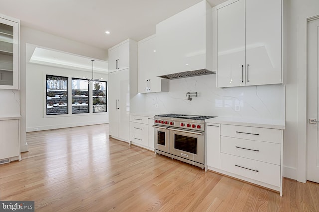 kitchen with double oven range and white cabinets