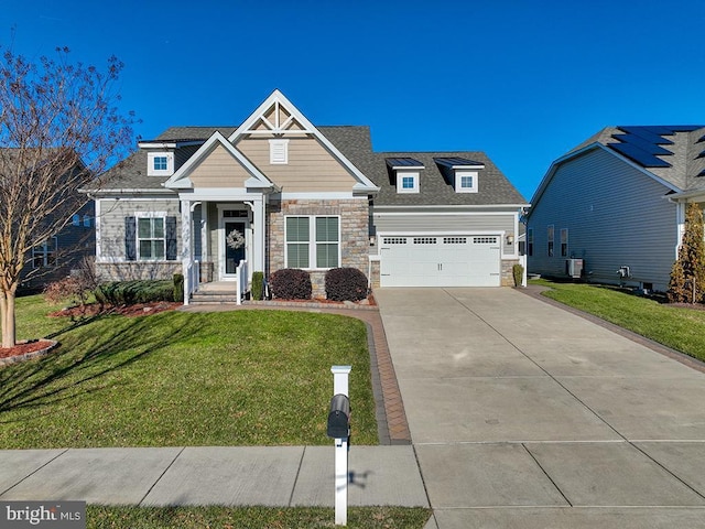 craftsman-style house with a front yard and a garage