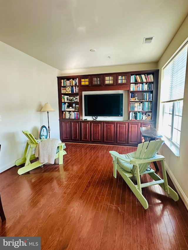 living room with a wealth of natural light and dark hardwood / wood-style floors