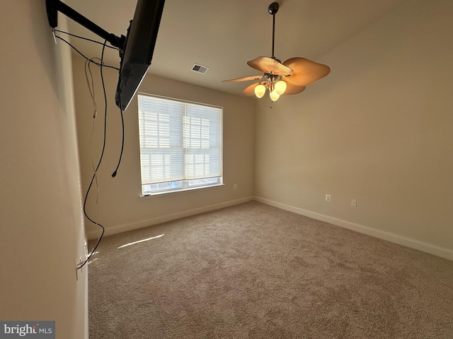 spare room featuring ceiling fan and light colored carpet