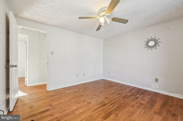 unfurnished room featuring a textured ceiling, ceiling fan, and hardwood / wood-style floors