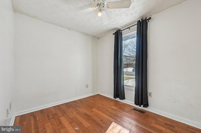 unfurnished room featuring wood-type flooring, a textured ceiling, and ceiling fan