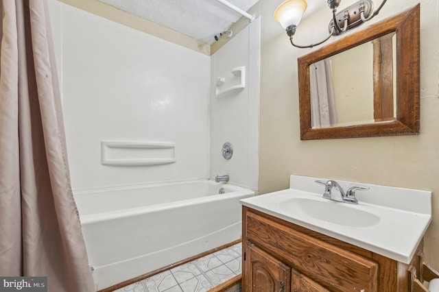 bathroom with vanity, a textured ceiling, and shower / bathtub combination with curtain