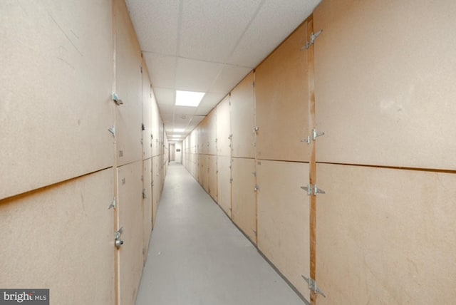 hallway with a paneled ceiling