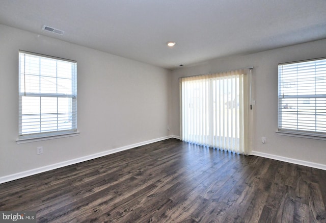 spare room with dark wood-type flooring