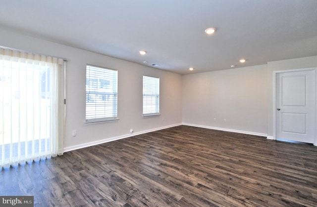 unfurnished room with dark hardwood / wood-style floors