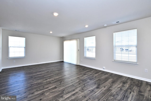 spare room featuring dark wood-type flooring