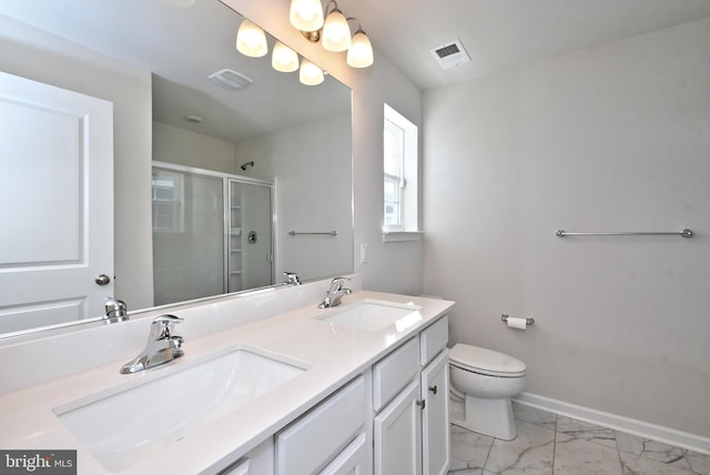 bathroom featuring vanity, toilet, and a shower with door