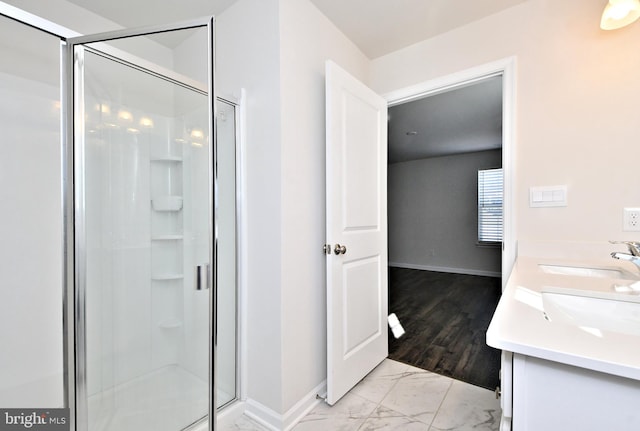 bathroom with vanity and a shower with shower door