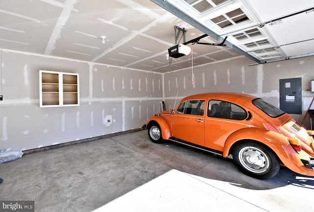 garage featuring electric panel and a garage door opener