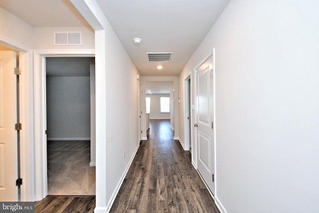 hallway with dark wood-type flooring