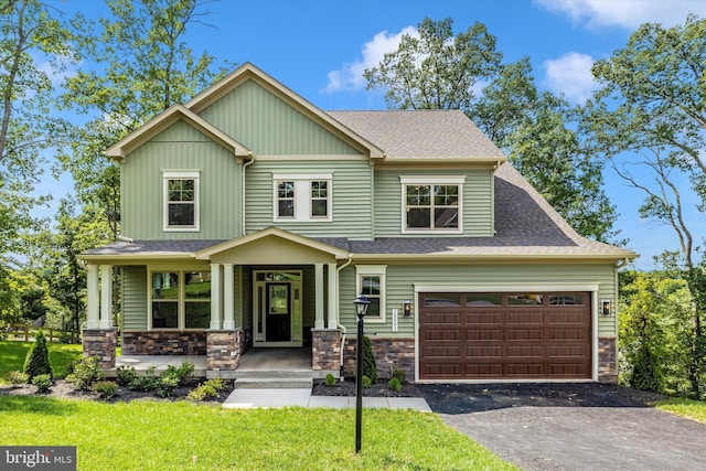 craftsman house featuring a porch and a garage