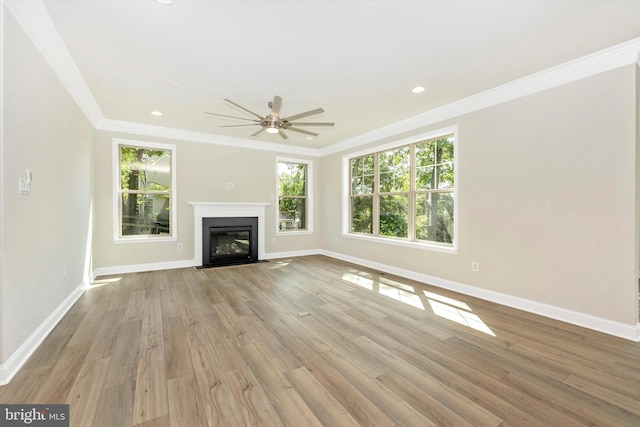 unfurnished living room featuring crown molding, ceiling fan, and light hardwood / wood-style floors