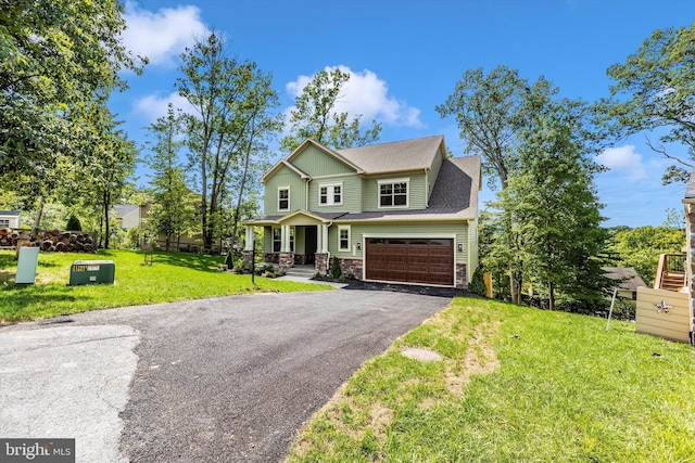 craftsman house featuring a garage and a front lawn