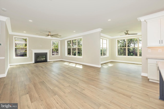 unfurnished living room with ceiling fan, light hardwood / wood-style floors, and crown molding