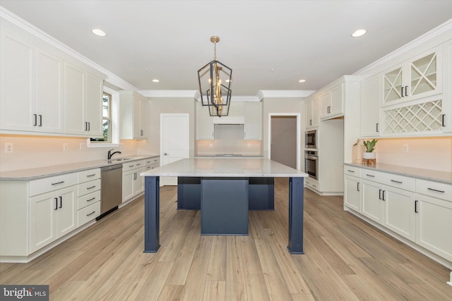 kitchen with stainless steel appliances, crown molding, light hardwood / wood-style flooring, a kitchen island, and hanging light fixtures