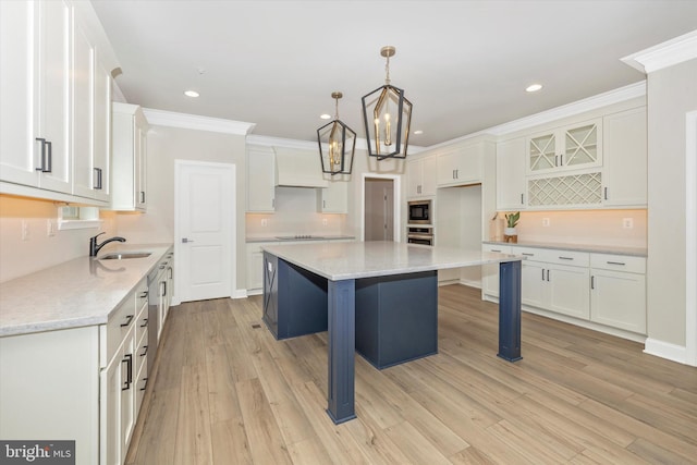 kitchen with built in microwave, a kitchen island, decorative light fixtures, a breakfast bar, and white cabinets