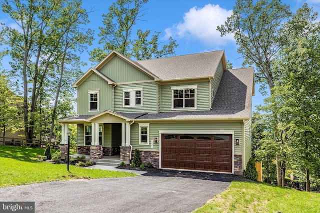 craftsman-style house featuring a front yard and a garage