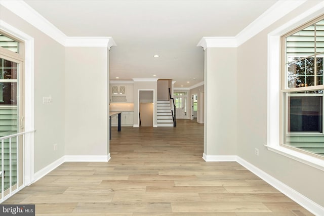 corridor featuring light hardwood / wood-style floors and ornamental molding