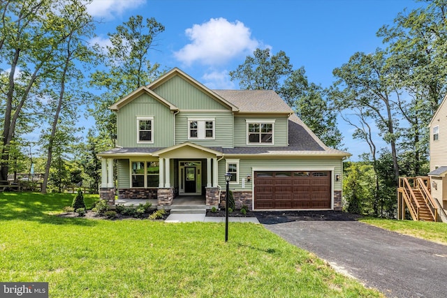 craftsman inspired home featuring covered porch, a front yard, and a garage