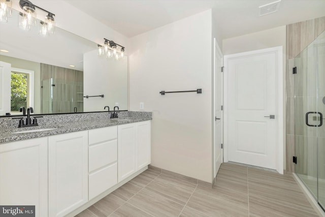 bathroom with tile patterned floors, vanity, and an enclosed shower