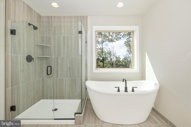 bathroom featuring shower with separate bathtub