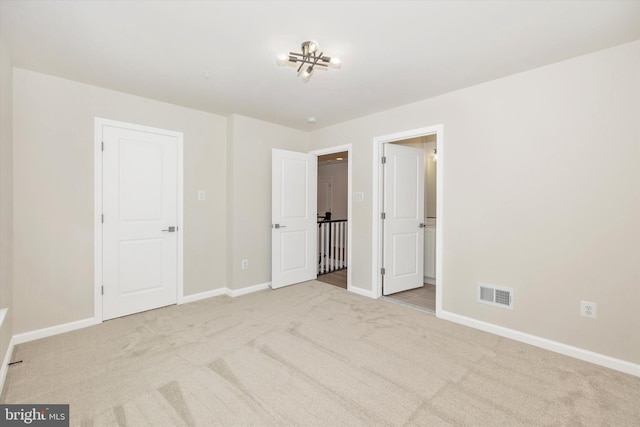 unfurnished bedroom featuring light colored carpet