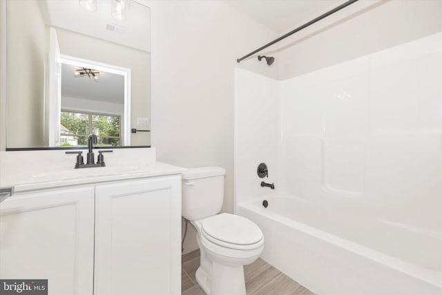 full bathroom featuring bathing tub / shower combination, vanity, and toilet