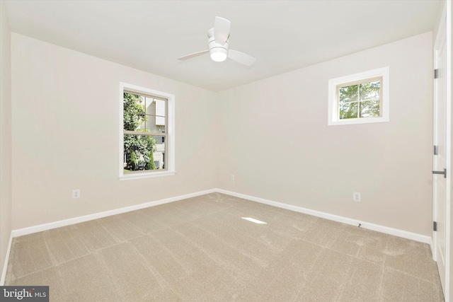 carpeted empty room featuring ceiling fan