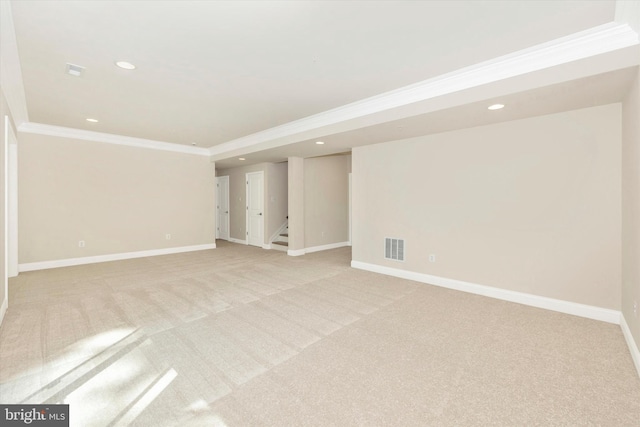 basement with light carpet and ornamental molding