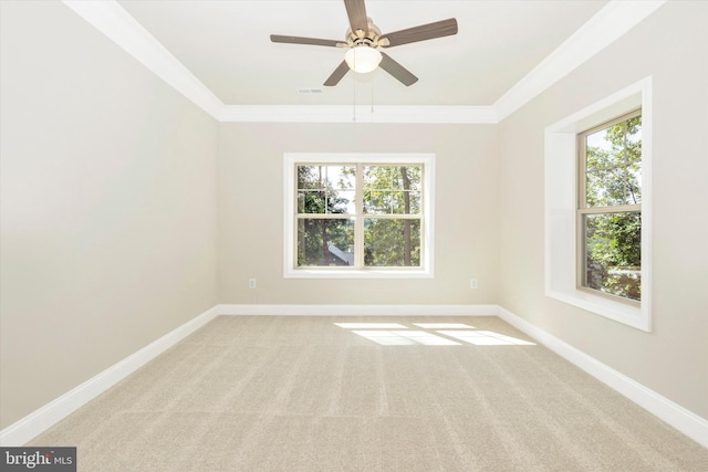 spare room with a wealth of natural light, ceiling fan, light carpet, and ornamental molding