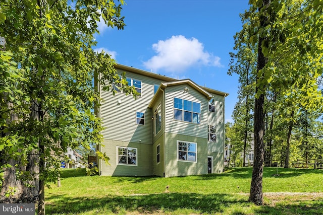 rear view of property featuring a yard