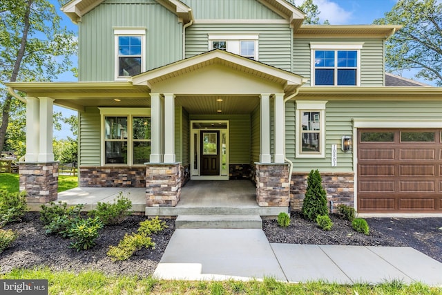 craftsman house with a porch and a garage