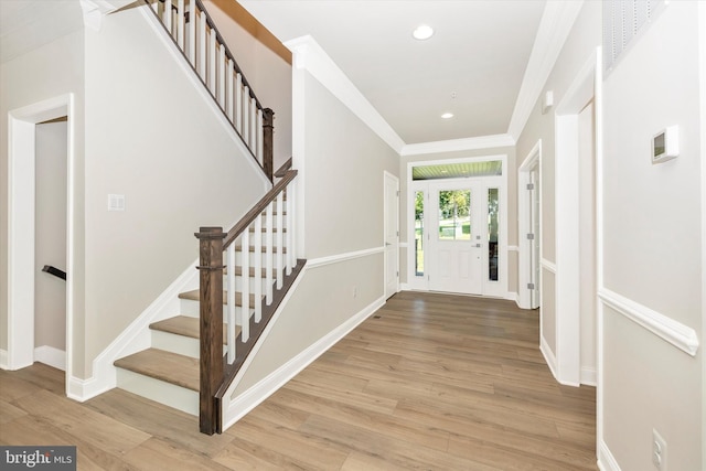 entrance foyer featuring crown molding and wood-type flooring