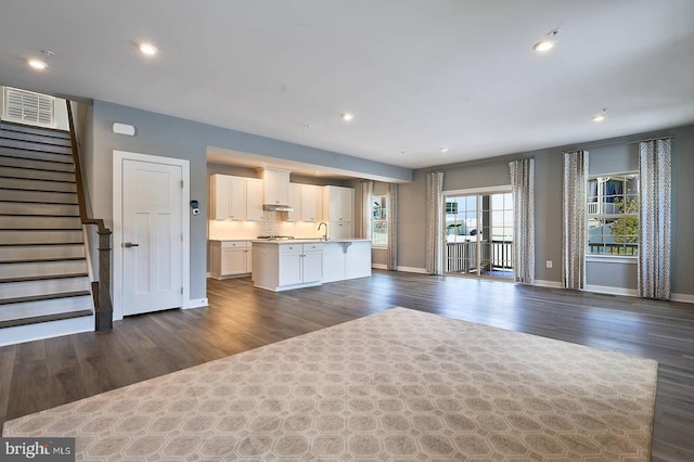 unfurnished living room featuring dark hardwood / wood-style flooring