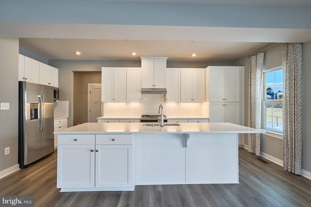 kitchen with sink, white cabinetry, stainless steel fridge, a center island with sink, and dark wood-type flooring