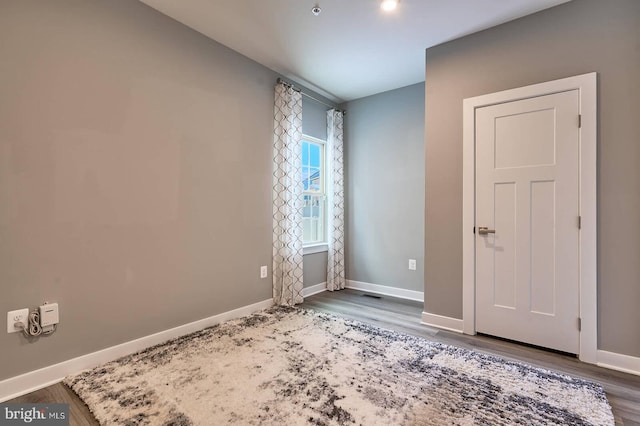 spare room with wood-type flooring