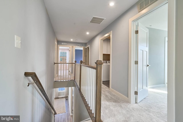 hallway featuring light carpet