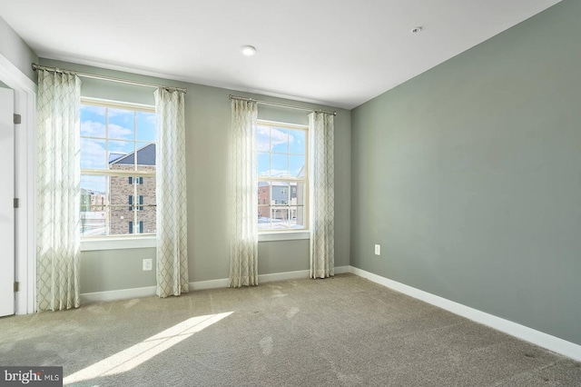 unfurnished room with light carpet and a wealth of natural light