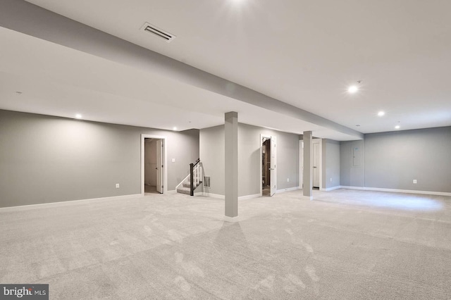 basement featuring light colored carpet