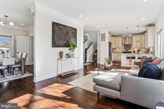 living area with baseboards, wood-type flooring, ornamental molding, stairs, and recessed lighting