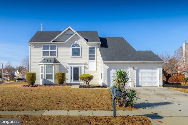 view of property with a garage and a front yard