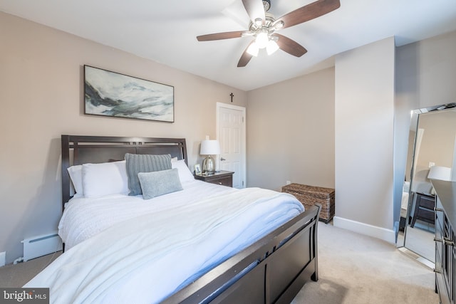 carpeted bedroom featuring ceiling fan and a baseboard heating unit