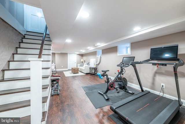 exercise room with dark wood-type flooring