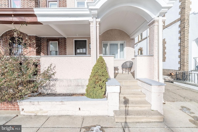 entrance to property featuring a porch