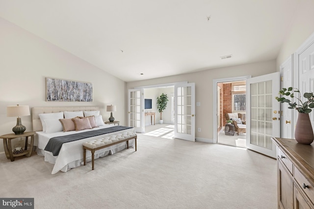 carpeted bedroom with access to exterior, french doors, and lofted ceiling