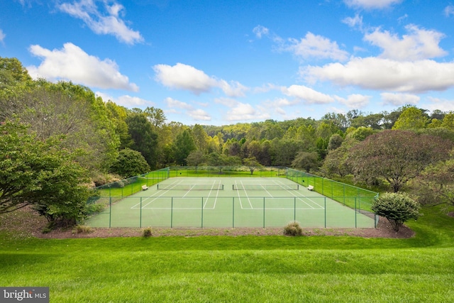 view of tennis court with a yard