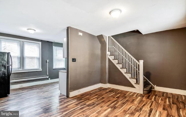 staircase with a baseboard radiator and wood-type flooring